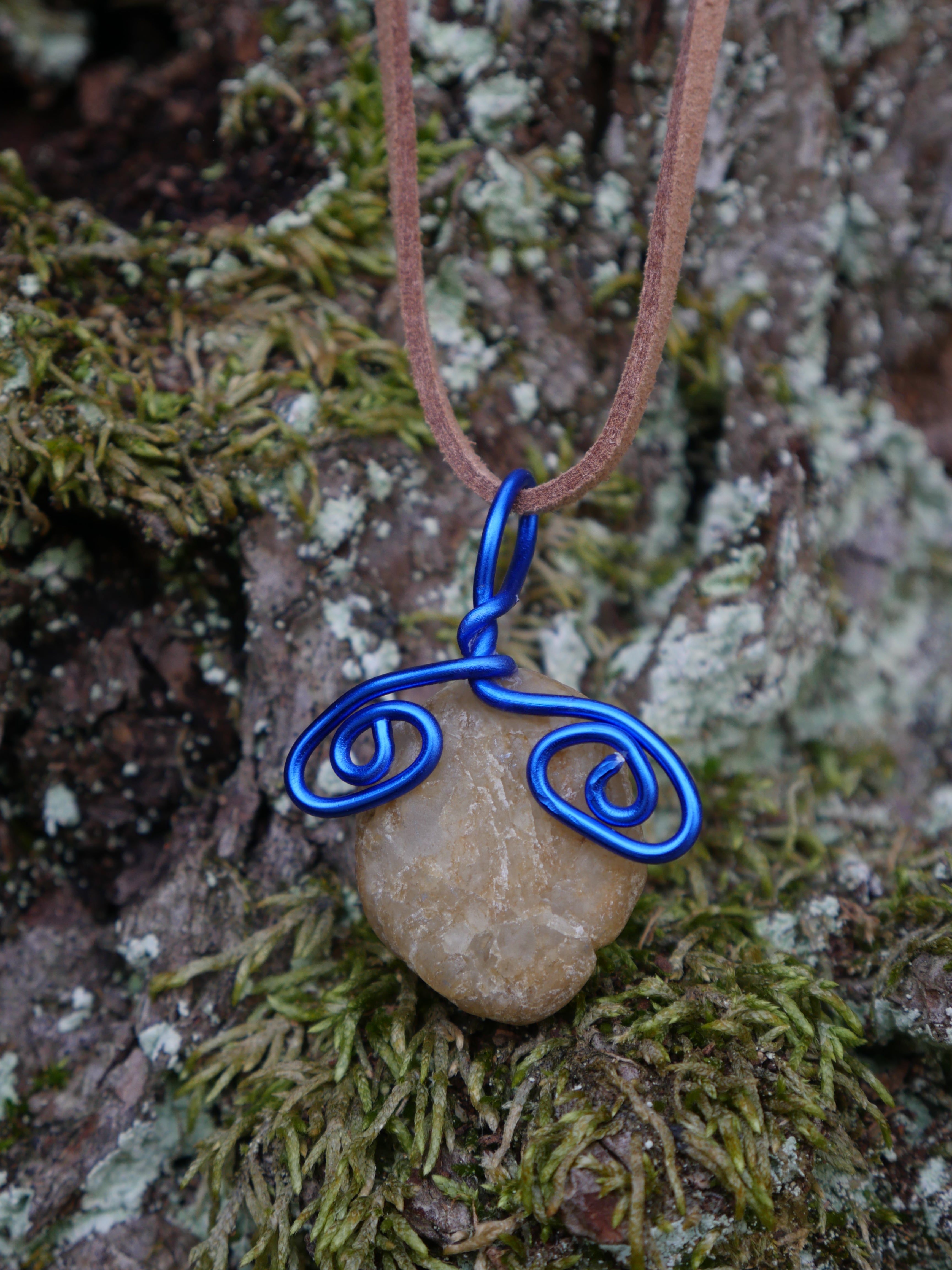 Blue wire eyes on a tan stone faux brown suede necklace