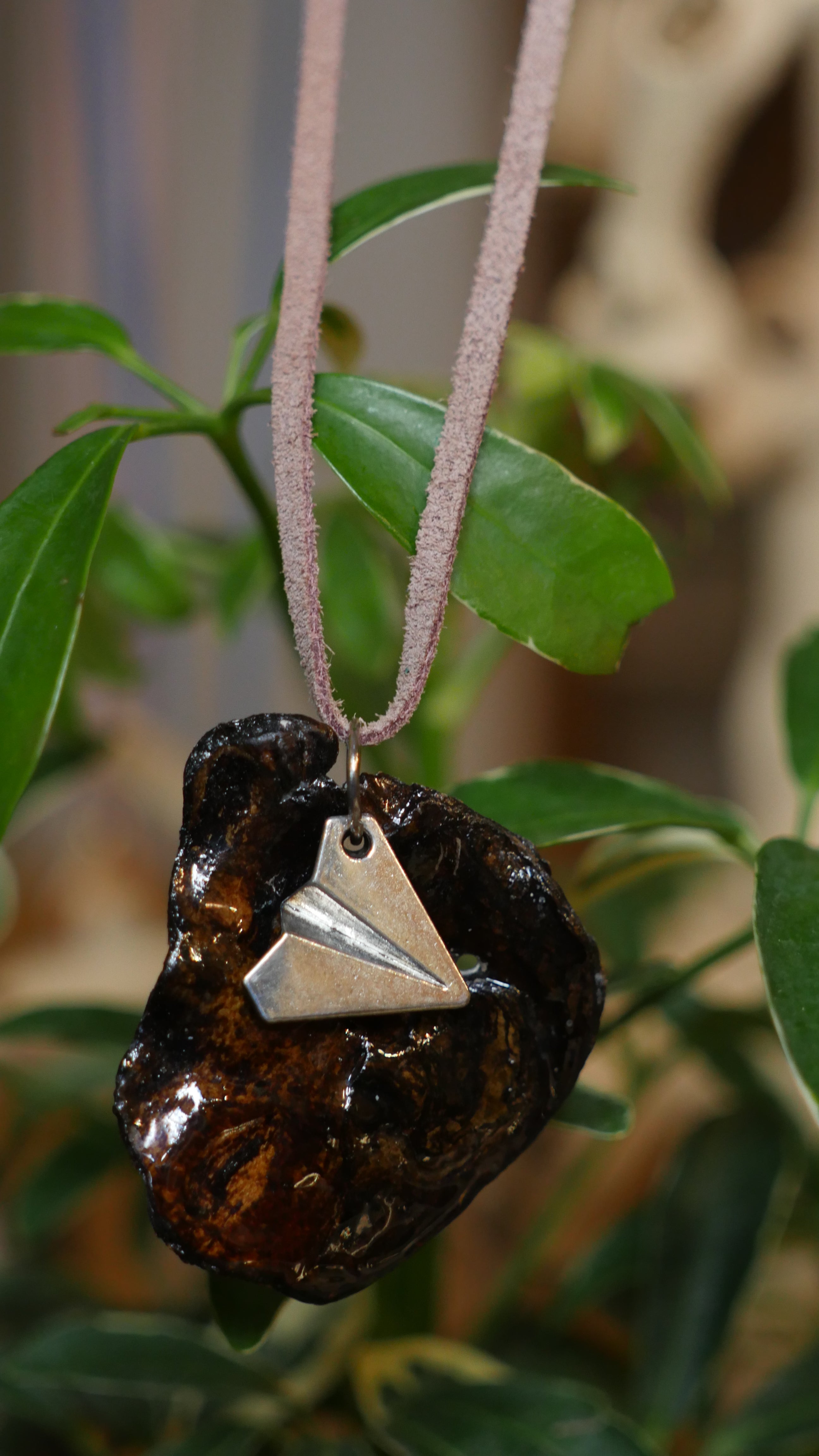 Silver paper plane charm on driftwood encased in acryllic on real mauve suede cord
