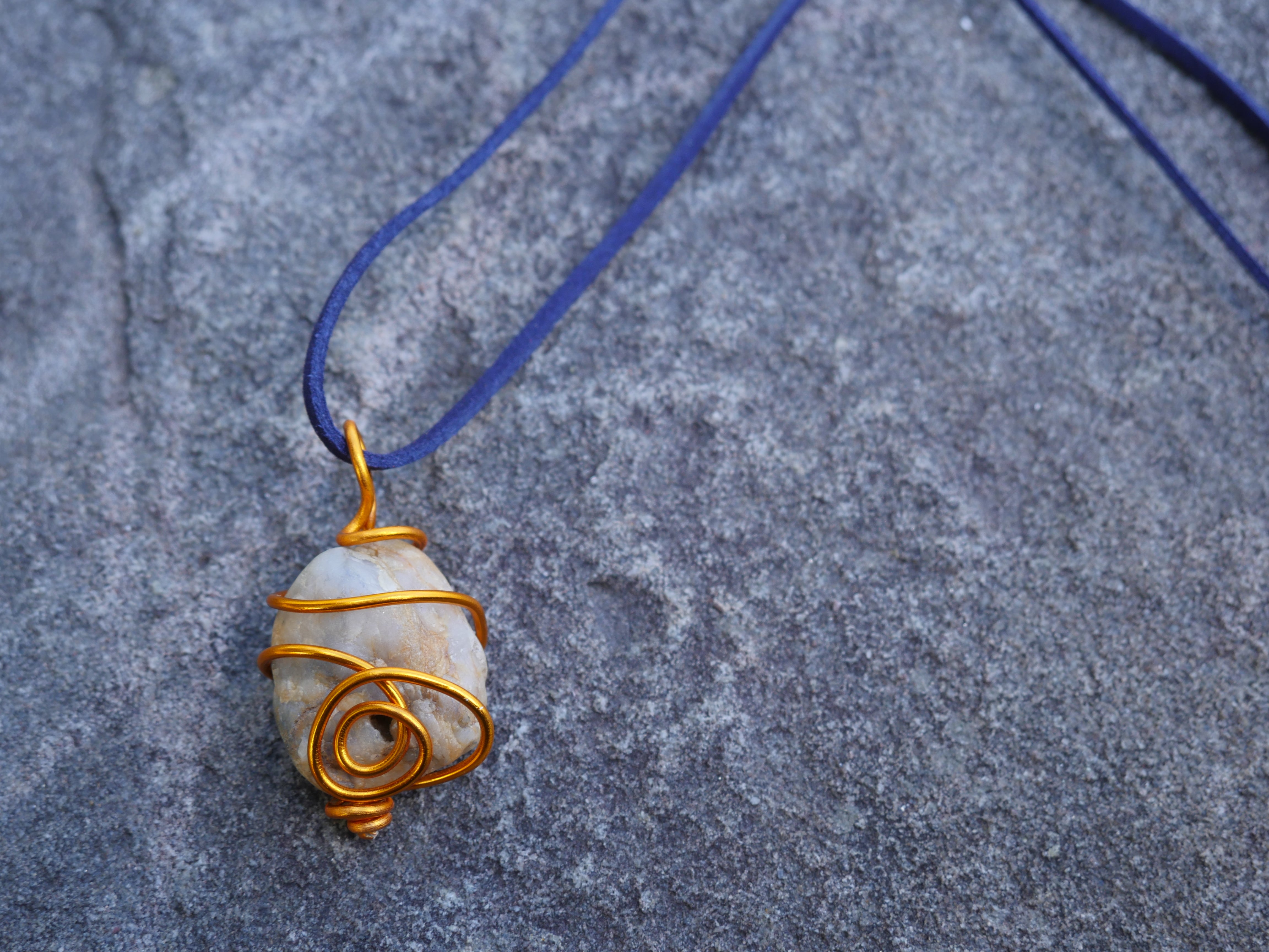 Orange wire wrapped beige stone navy suede necklace
